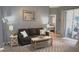 Cozy living room with modern furniture, decorative rug, and sliding glass doors to let in natural light at 146 Essex Pl, Davenport, FL 33896