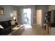 Comfortable living room featuring a sofa, wood-look flooring, and sliding glass doors for outdoor access at 146 Essex Pl, Davenport, FL 33896