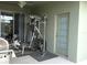 Covered patio featuring exercise equipment, offering a space for fitness and leisure in a home setting at 146 Essex Pl, Davenport, FL 33896
