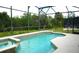 A screened-in pool featuring a spa and deck offers a private outdoor retreat for relaxation and enjoyment at 146 Essex Pl, Davenport, FL 33896