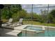 Outdoor pool with an in-ground spa enclosed with a screen, perfect for relaxation and entertainment at 146 Essex Pl, Davenport, FL 33896