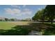 Scenic tennis courts and community lawn create a vibrant recreation area with serene surroundings for friendly matches at 146 Essex Pl, Davenport, FL 33896