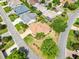 A beautifully landscaped home seen from above, showcasing its appealing curb appeal and neighborhood setting at 1561 Loris Loop, The Villages, FL 32162