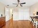 Bedroom with ceiling fan, wood floor, desk and double-door closet, offering comfort and functionality at 1561 Loris Loop, The Villages, FL 32162