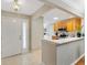 Bright foyer adjacent to a kitchen with light wood cabinets and modern appliances at 1561 Loris Loop, The Villages, FL 32162