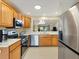 Well-lit kitchen boasting stainless steel appliances and ample counter space at 1561 Loris Loop, The Villages, FL 32162