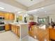Open concept kitchen flows into the living room with wood floors and comfortable furnishings at 1561 Loris Loop, The Villages, FL 32162