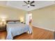 Spacious main bedroom featuring hardwood floors and tray ceiling at 1561 Loris Loop, The Villages, FL 32162