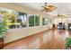 Bright sunroom with laminate flooring and views of the landscaped backyard at 1561 Loris Loop, The Villages, FL 32162