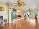 Bright sunroom with hardwood floors, ceiling fans, and sliding doors at 1561 Loris Loop, The Villages, FL 32162