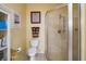 Bright bathroom features a walk-in shower, tiled floor, decorative wall mirror, and neutral color scheme at 1723 Carrera Dr, The Villages, FL 32159