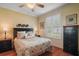 Comfortable bedroom with wood flooring, plantation shutters, ceiling fan, and traditional furnishings at 1723 Carrera Dr, The Villages, FL 32159