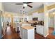 Kitchen featuring white cabinets, stainless steel appliances, and wood flooring at 1723 Carrera Dr, The Villages, FL 32159