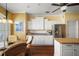 Well-lit kitchen with white cabinets, stainless appliances, and breakfast nook at 1723 Carrera Dr, The Villages, FL 32159