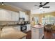 Eat-in kitchen featuring white cabinetry, stainless appliances and natural light at 1723 Carrera Dr, The Villages, FL 32159