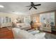 Bright living room with hardwood floors, comfortable couches, and view of dining area through the French doors at 1723 Carrera Dr, The Villages, FL 32159