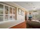 Inviting living room with hardwood floors, plantation shutters, and sliding glass door to a patio at 1723 Carrera Dr, The Villages, FL 32159