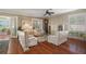 Inviting living room with hardwood floors, plantation shutters, neutral paint, and comfortable seating arrangement at 1723 Carrera Dr, The Villages, FL 32159