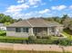 Charming home featuring a screened lanai, well-kept landscaping, and partial fencing at 1723 Carrera Dr, The Villages, FL 32159