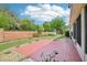 A well-maintained backyard with a brick patio, lush lawn, and established landscaping at 179 Patrice Hope St, Leesburg, FL 34748