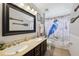 Bathroom featuring a double vanity, framed mirror, and shower with a curtain at 179 Patrice Hope St, Leesburg, FL 34748