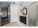 Bathroom with a walk-in shower, dark vanity, and tile flooring at 179 Patrice Hope St, Leesburg, FL 34748