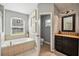 Bright bathroom with soaking tub, walk-in shower, and modern vanity at 179 Patrice Hope St, Leesburg, FL 34748