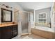 Bathroom featuring a glass shower and soaking tub with natural light at 179 Patrice Hope St, Leesburg, FL 34748