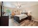 Bedroom with wood-look flooring, ceiling fan, and nautical decorations at 179 Patrice Hope St, Leesburg, FL 34748