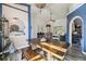 Bright dining room with wood floors, archway, decorative art, and stylish lighting fixture at 179 Patrice Hope St, Leesburg, FL 34748