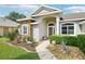 Inviting front entrance featuring stone accents, mature landscaping, and walkway at 179 Patrice Hope St, Leesburg, FL 34748