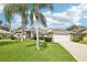 Charming single-story home featuring a well-manicured lawn, stone accents, and a two-car garage at 179 Patrice Hope St, Leesburg, FL 34748