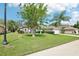 Charming single-story home featuring a well-manicured lawn, stone accents, and a two-car garage at 179 Patrice Hope St, Leesburg, FL 34748