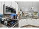 Well-lit kitchen features granite counters, stainless steel appliances, and stylish fixtures at 179 Patrice Hope St, Leesburg, FL 34748