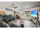 Relaxing living room with leather seating, wood floors, decoratively-shelved vaulted ceilings, and abundant natural light at 179 Patrice Hope St, Leesburg, FL 34748