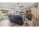 Spacious living room with wood floors, ceiling fan, and comfortable seating at 179 Patrice Hope St, Leesburg, FL 34748