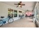 Relaxing screened patio featuring neutral tile flooring, ceiling fans, comfortable seating and outdoor dining at 179 Patrice Hope St, Leesburg, FL 34748