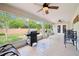 Screened patio with grill and ceiling fans overlooking the backyard at 179 Patrice Hope St, Leesburg, FL 34748