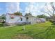 Manicured backyard features a spacious lawn and a detached garage at 1901 Brookside Dr, Mount Dora, FL 32757