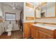 Neutral bathroom featuring a single sink vanity, toilet and a walk-in shower at 1901 Brookside Dr, Mount Dora, FL 32757