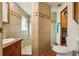 Cozy bathroom featuring tiled walk-in shower, single sink vanity and neutral color scheme at 1901 Brookside Dr, Mount Dora, FL 32757