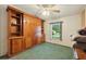 Bedroom showcasing a built-in wooden storage unit and green carpet at 1901 Brookside Dr, Mount Dora, FL 32757