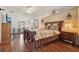 Bedroom with decorative bed frame, wooden floors, and ceiling fan at 1901 Brookside Dr, Mount Dora, FL 32757
