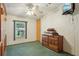 Cozy bedroom featuring a ceiling fan, dresser, and green carpet at 1901 Brookside Dr, Mount Dora, FL 32757