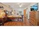 Spacious bedroom featuring wood floors, rustic wood furniture, and a ceiling fan at 1901 Brookside Dr, Mount Dora, FL 32757