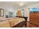 Comfortable bedroom showcasing hardwood floors, ceiling fan, and mounted television at 1901 Brookside Dr, Mount Dora, FL 32757
