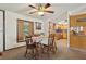Dining room with wooden table and chairs adjacent to kitchen with wood cabinets at 1901 Brookside Dr, Mount Dora, FL 32757