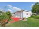 Detached one car garage with red trim and ample green space at 1901 Brookside Dr, Mount Dora, FL 32757
