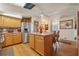 Bright kitchen with island, stainless steel appliances, and wood cabinets at 1901 Brookside Dr, Mount Dora, FL 32757