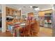 Bright kitchen with wood cabinets and a dining area with flowers on the table at 1901 Brookside Dr, Mount Dora, FL 32757